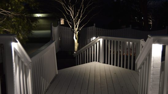 New white patio and deck with edison lighting