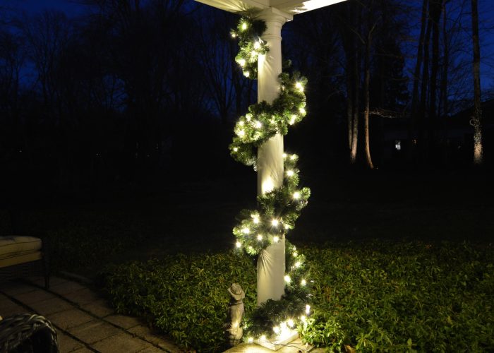 Holiday lighting on pilar of front porch of house