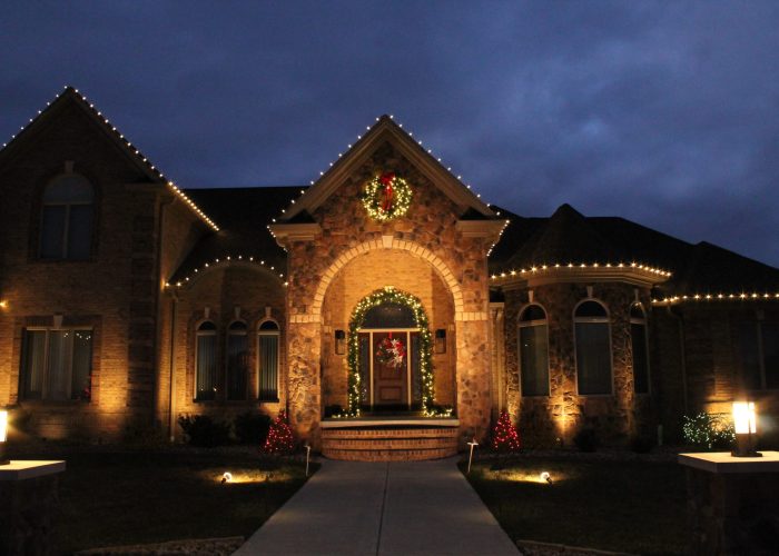 Front of house with holiday lighitng and accent lighting