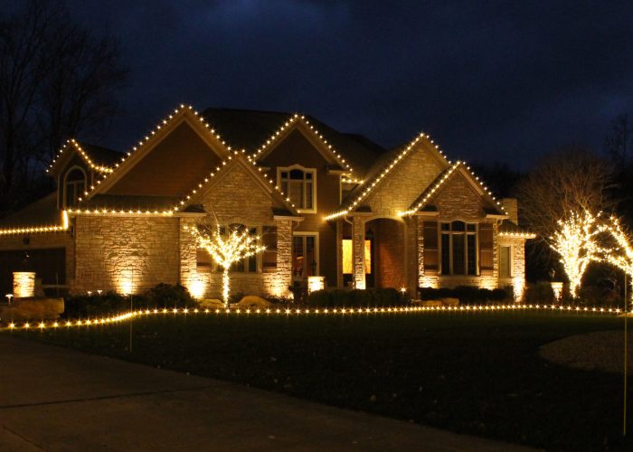 House with white colored holiday lighting in dark